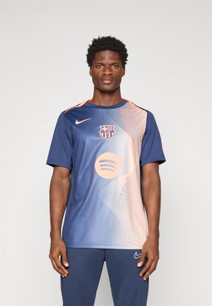Nike Barcelona jersey in navy with an orange gradient design, featuring the team logo and Spotify logo at the center. Short sleeves.
