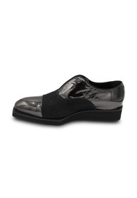 Schwarzer Slipper aus strukturiertem schwarzem Stoff mit glänzender metallischer Zehenkappe. Verfügt über eine niedrige Keilsohle und glatte, glänzende Akzente.