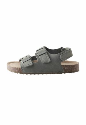 Gray open-toe sandal with two adjustable buckle straps and a Velcro ankle strap, featuring a cork-textured sole and cushioned footbed.