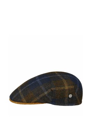 Flat cap in blue and brown plaid wool with a small round metal brand emblem on the side and a mustard-colored brim edge.