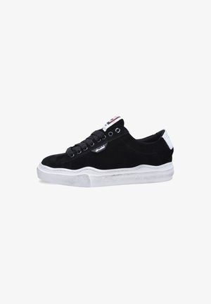 Black suede sneakers with white rubber sole, round laces, and a branded tag on the tongue. Smooth texture and classic low-top design.