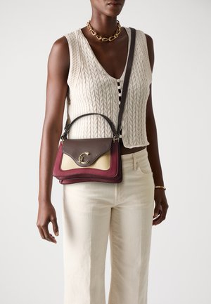 Brown and burgundy leather handbag with a gold logo, featuring a textured surface and layered design. Accompanied by a shoulder strap.