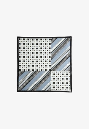Foulard carré avec des sections noires, blanches et bleues présentant une grille de carrés et de cercles ainsi que des rayures diagonales, encadré par une bordure noire.