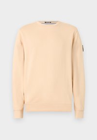 Beige sweatshirt with a round neckline and long sleeves. Features ribbed cuffs and hem, made from soft cotton material. Black logo patch on sleeve.