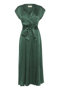 Green wrap dress with short sleeves, textured fabric, adjustable tie at the waist, and a flowing skirt reaching below the knee.