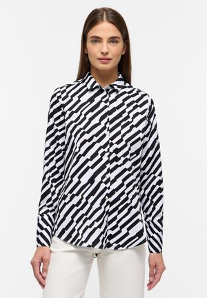 Black and white patterned button-up shirt, featuring a zigzag design, long sleeves, and a classic collar. Fabric has a smooth texture.