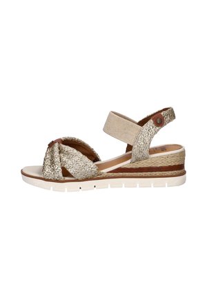 Beige geweven sleehak sandaal met enkelriem, knopen aan de voorkant, leren accenten en een witte rubberen zool.