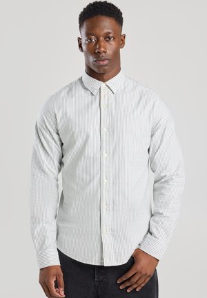 Striped button-up shirt in light grey and white, featuring long sleeves, standard collar, and button front closure, made of smooth fabric.