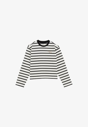 Langærmet top i hvidt stof med sorte vandrette striber, med rund hals og broderede detaljer i guldtråd på brystet.