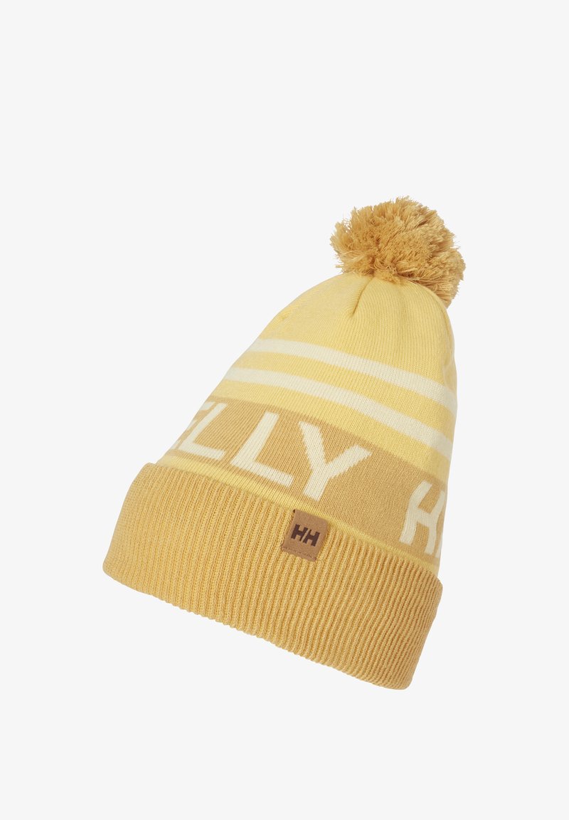 Gorro de punto amarillo con rayas blancas, un pompón esponjoso en la parte superior y un parche con el logo "HH". Puño texturizado acanalado en la base.