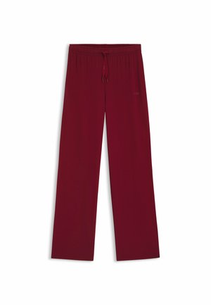Pantaloni larghi color bordeaux realizzati in tessuto morbido, con vita elastica e cordino regolabile, e un branding discreto sul lato.