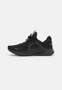 Scarpe sportive nere con tomaia in mesh, suola ammortizzata e design flessibile. Presentano un marchio prominente sul lato e dettagli testurizzati.