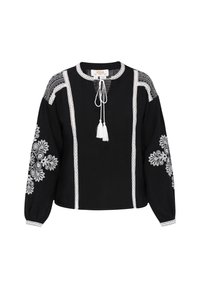 Blusa nera con ricami floreali bianchi, dettagli in pizzo e colletto con laccetto. Presenta maniche lunghe arricciate e una vestibilità rilassata.