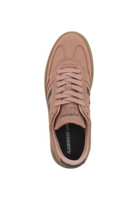 Pink suede sneaker with a white sole, featuring black stripes, round laces, and logo text on the tongue and insole. Textured upper design.