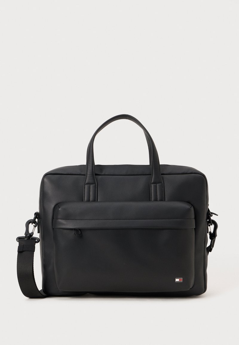 Black laptop bag made of smooth synthetic material with textured front panel, dual handles, adjustable strap, and logo accent on the lower front.