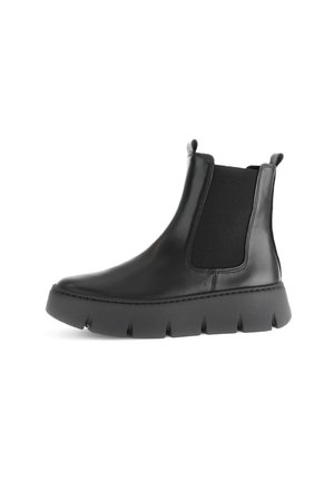 Bottines Chelsea en cuir noir avec des panneaux latéraux élastiques, un bout arrondi et une semelle en caoutchouc épaisse et texturée.