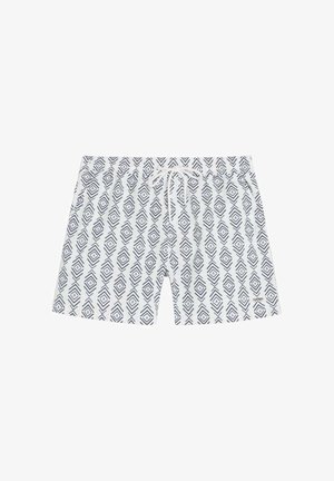 Bañador blanco con patrones geométricos de diamantes negros y una cintura con cordón blanca.