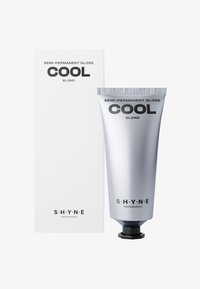 Sølvrør mærket "Semi-Permanent Gloss Cool Blond" ved siden af en hvid æske med sort tekst. Røret har en sort hætte og metaltekstur.