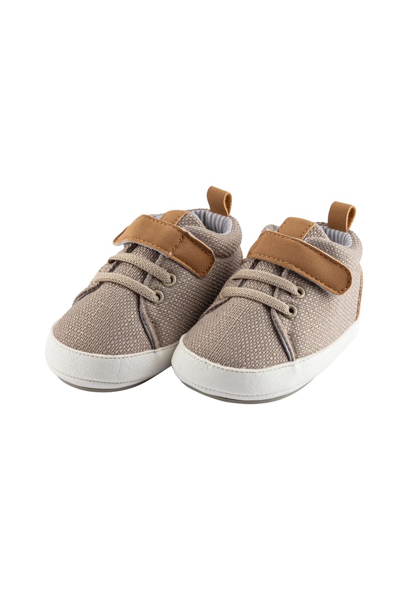 Light brown fabric shoes with a textured finish, white rubber soles, and brown leather accents. Features laces and a velcro strap for closure.