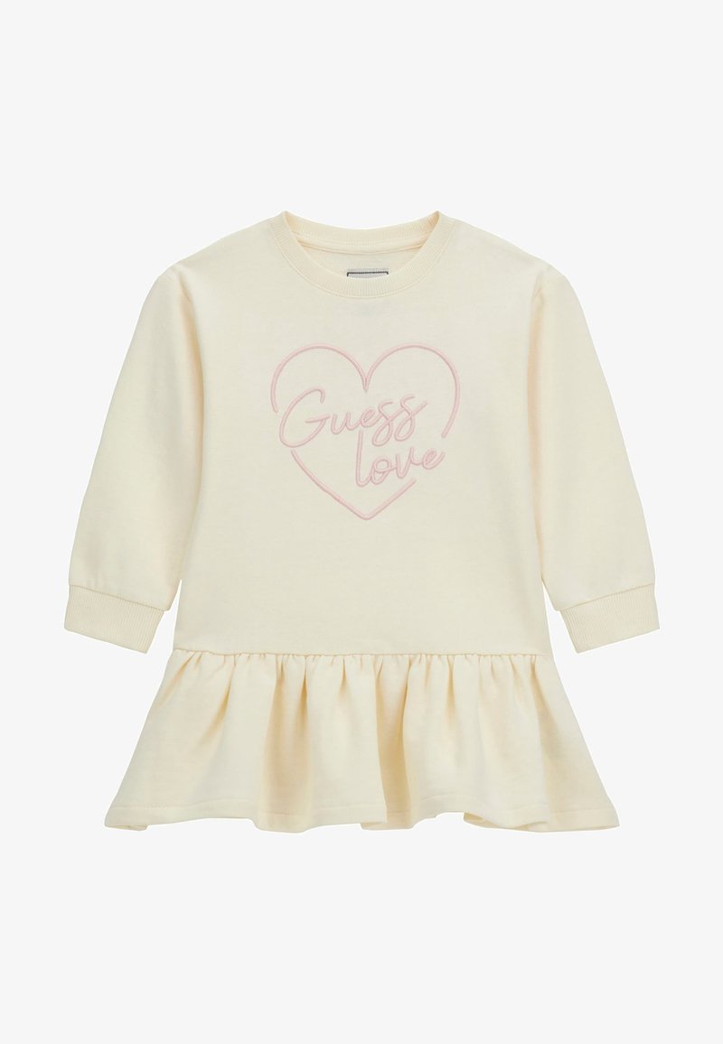 Robe pour tout-petit à manches longues couleur crème avec ourlet à volants et contour de cœur rose, ornée du texte « Guess love » sur la poitrine.