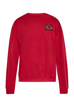Punainen huppari, jossa on pyöreä kaula-aukko, pitkät hihat ja ribatut hihansuut. Rinnassa on brodeerattu logo. Tasainen rakenne.