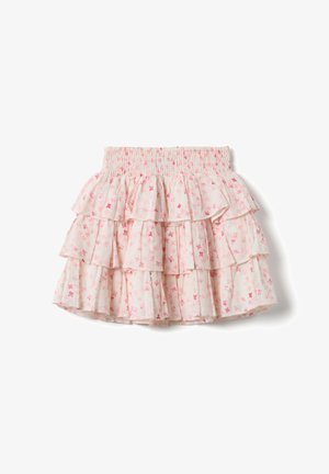 Jupe à volants rose et blanche à motifs floraux, avec taille froncée et détails à volants, sur fond blanc.