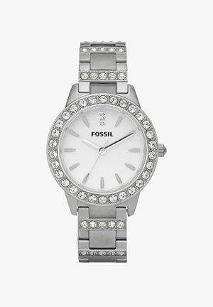 Orologio in acciaio inox argentato con quadrante circolare, fondo bianco e lunetta decorata con cristalli. Presenta indici delle ore argentati e maglie.