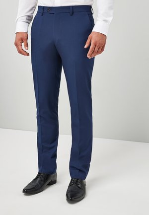 Marinblå kostymbyxor i slim fit, med slät front, bälten och en enkel knäppning; tillverkade av ett smidigt tyg.
