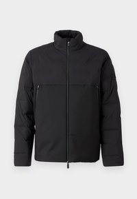 Black puffer jacket with a high collar, zippered front, and side pockets. Features a smooth texture and contrasting fabric panels.
