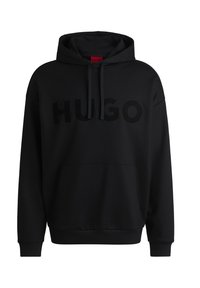 Sudadera negra con capucha que presenta un gran logotipo brillante de "HUGO" en la parte frontal. Está hecha de un tejido suave con un bolsillo tipo canguro y capucha con cordón.