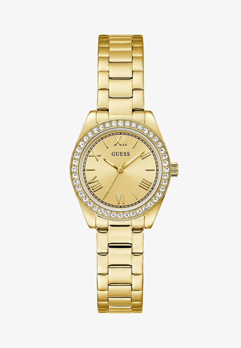 Montre dorée avec un cadran rond, des chiffres romains et une lunette sertie de cristaux. Elle dispose d'un bracelet en métal maillé avec une finition polie.