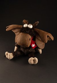Brown plush moose with large ears, white eyes, and a black nose. Features a red scarf with a white maple leaf. Soft fur texture.