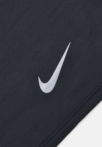Nike black fabric with a smooth texture features a prominent silver Swoosh logo on the side, and clean stitched detailing along the edges.