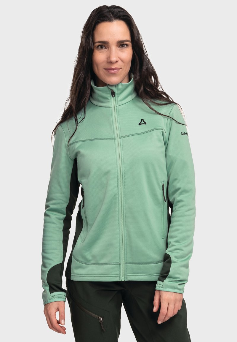 Hellgrüne Fleecejacke mit hohem Kragen, schwarzen Akzenten und Seitentaschen, ausgestattet mit einem Reißverschluss und strukturiertem Stoff.