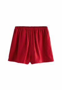 Røde bomulds shorts med elastisk talje, der har to sidelommer og en løs pasform. Glat tekstur og knælangt design.