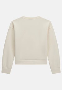 Felpa a maniche lunghe color crema con collo tondo, polsini a costine e orlo corto. Tessuto liscio, senza fantasie o hardware visibile.