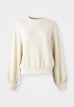 Cream-colored sweatshirt with a round neckline, ribbed hem, and balloon sleeves. Made from a smooth, lightweight fabric.
