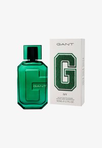 Green GANT branded perfume bottle and white box with large textured green "G" and product details for men's eau de toilette.