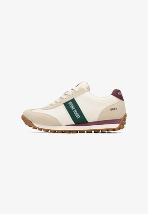 Zapatilla beige y blanca con franja verde y texto, suela de goma, material de ante y sintético, puntera redonda y diseño tradicional con cordones.
