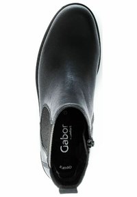 Bottine noire avec tige en cuir lisse, inserts élastiques sur les côtés, bout rond et fermeture éclair. Doublure intérieure douce pour le confort.