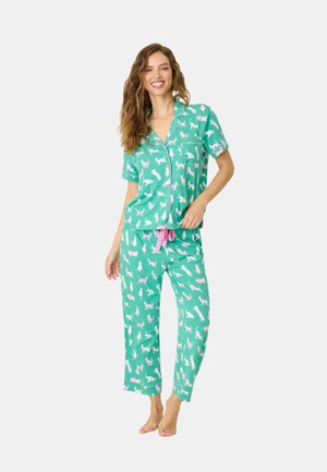 Short-sleeve, button-up pajamas in teal with white and pink cat patterns, featuring pink accents and loose-fit pants.