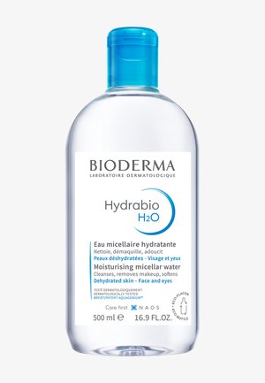 Bouteille en plastique transparent avec un bouchon bleu, contenant 500 ml d'eau micellaire Bioderma Hydrabio H2O. L'étiquette présente un texte blanc et des accents bleus.