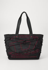 Black tote bag with red accents, made of textured material. Features external netting and dual handles, with branding on the front.