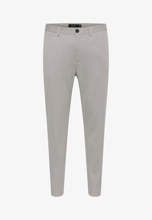 Heledad hallhallide teksilest, millel on nööbid, küljetaskud ja kitsas lõige.