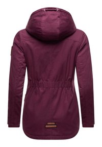 Maroon jacket with a hood, drawstring detail, elastic waistband, and ribbed cuffs. Features a textured fabric and branded accents.