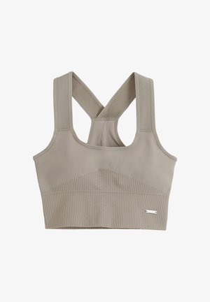 Športni modrček svetlo turske barve z širokimi naramnicami in rebrastim pasom, z racerback dizajnom in majhno kovinsko znamko spredaj.