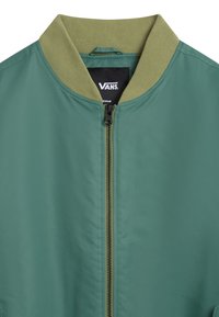 Green bomber jacket with a ribbed khaki collar, front zipper, and smooth fabric texture. Includes a small logo tag inside.
