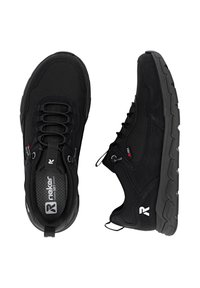 Black athletic shoes with a textured upper, lace-less design, cushioned sole, and distinctive logo on the side and tongue. Durable construction.