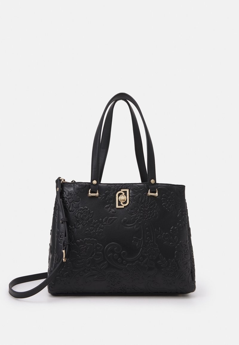 Zwarte leren handtas met een reliëf bloemenpatroon, dubbele handgrepen, gouden hardware accenten en een afneembare schouderriem. Gladde textuur.