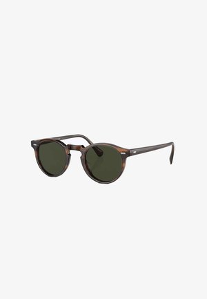 Occhiali da sole rotondi con montatura in tartaruga, lenti verde scuro e aste sottili. Presentano un ponte a chiave e piccoli dettagli in argento.